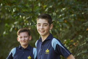 Two Leigh Academy Longfield students in PE kits smile for the camera.