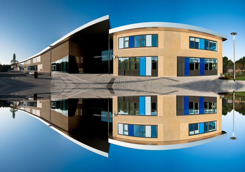 Vertically mirrored image of the outside of the Leigh Academy Longfield building, showing the entrance to the left.