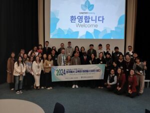 A group photo of people smiling and holding up a banner
